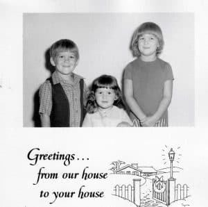 A 1970s Christmas card with a black and white photo of three kids 