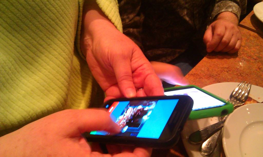 Restaurant customers use their smartphones at the table.