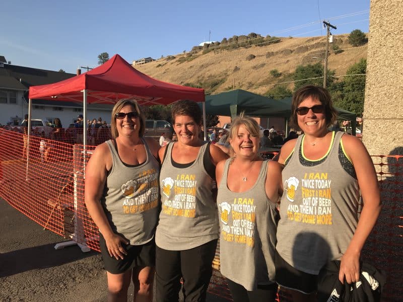 Four runners with matching shirts "I ran twice today. First I ran out of beer, then I ran out to get some more"