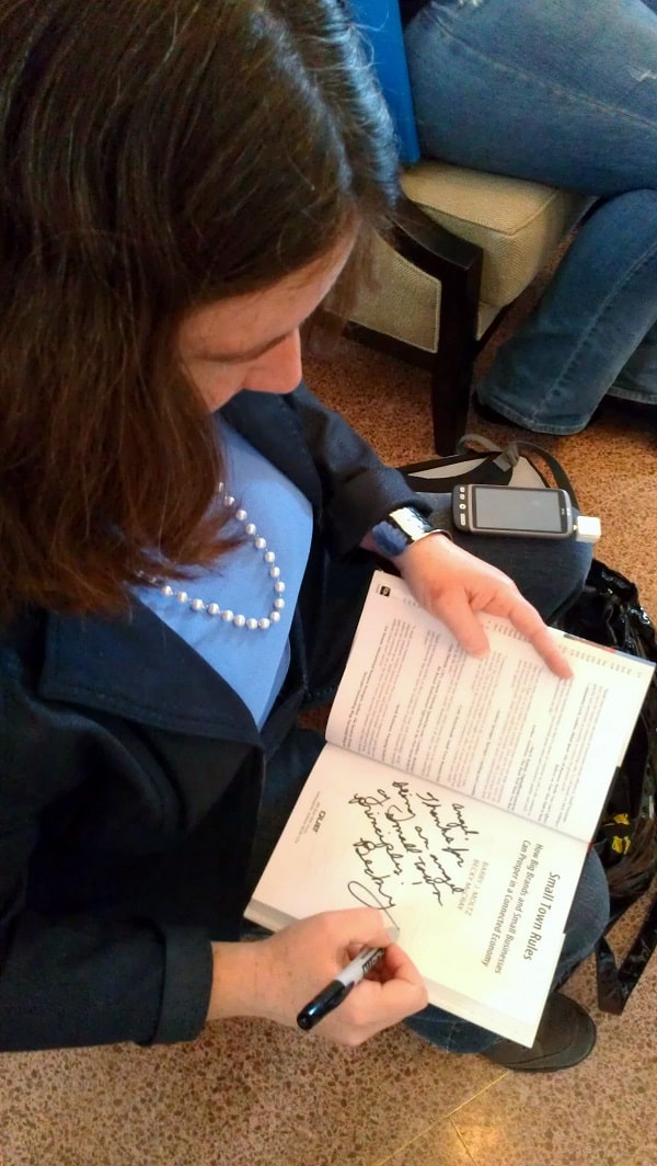 Signing my book at Social Media Tulsa Conference, after accepting payment via Square.