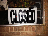 "Closed" sign in a business window. 