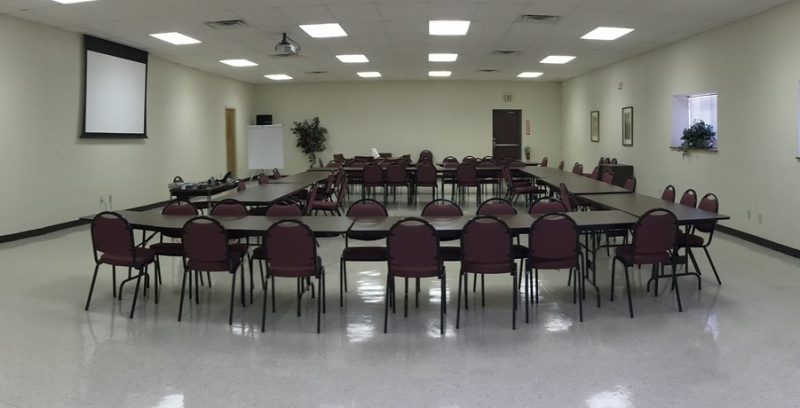 Chairs and tables set up for a town board or city council type meeting