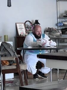 A man dressed in an Easter Bunny costume checks his phone. 