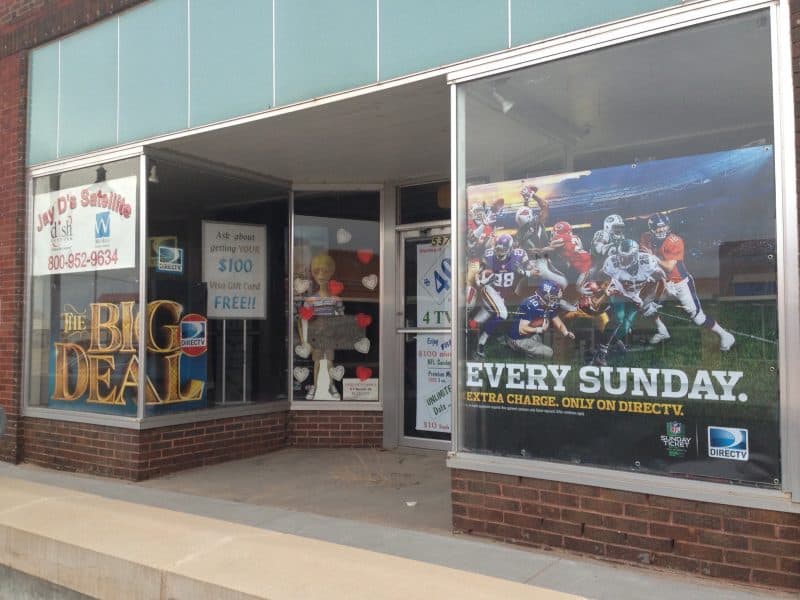 Empty building with windows advertising a satellite TV business