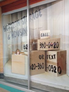 Empty building with windows advertising a moving and storage business