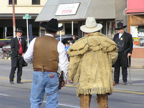 Cowboy re-enactment group the Dog Creek Gunfighters square off for a fight in downtown Alva.