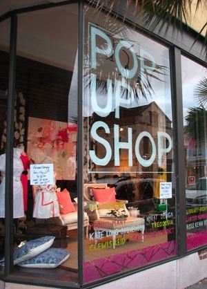 Store window with a sign that says, "Pop up shop."