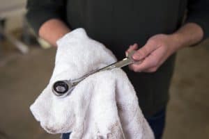 Mechanic wiping down a wrench