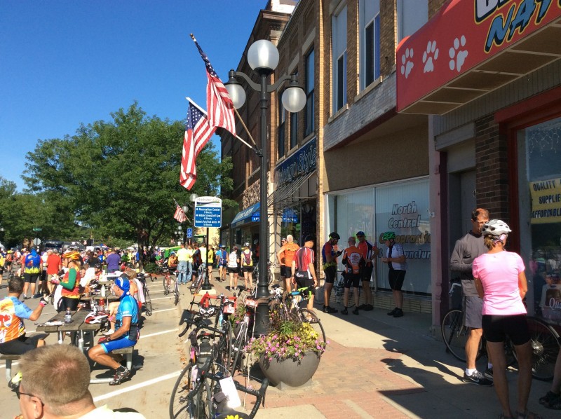 What can a business do when downtown is packed full of people who aren't shopping for what you sell? RAGBRAI cyclists gather, but don't necessarily shop, in downtown Webster City, Iowa. Photo by Deb Brown, used by permission. 