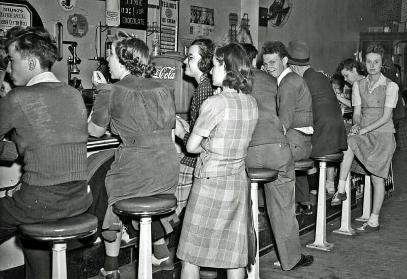 Customers crowd a 1950s soda fountain