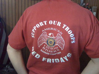 Red T-shirt says, "Support our troops. Red Fridays. American Legion Riders, Kansas Chapter."