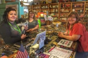 A busy retail store with diverse women shopping and working.