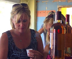 Woman tries a wine sample. 