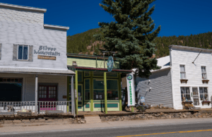 Small downtown building with a marijuana dispensary sign and flag.